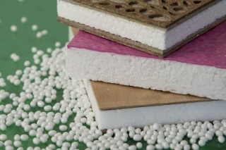 The photo shows three panel-shaped material samples made from white, solid foam with top layers comprised of various materials.